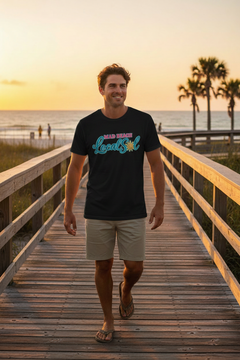 Man wearing black MAD Beach Local Sol tee with light shorts on a Florida beach