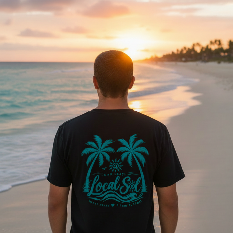 Back of Under the Palms Tee Teal on man at Florida beach golden hour