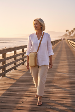 Older Woman on Boardwalk with Straw Crossbody Bag